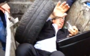 Not Nice: Ex-minister thrown into rubbish bin by angry mob (photos)