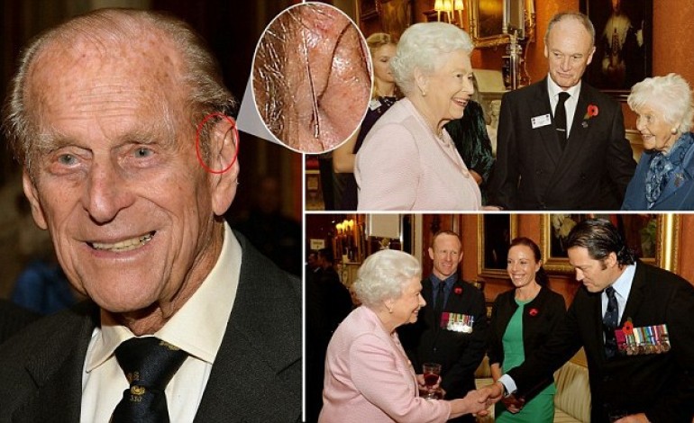 Prince Philip is seen with a hearing aid for the first time as he and the Queen meet hero Victoria Cross veterans in London