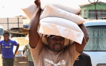 WOW! SEE T.B. Joshua carrying Three Bags of Rice on His Head