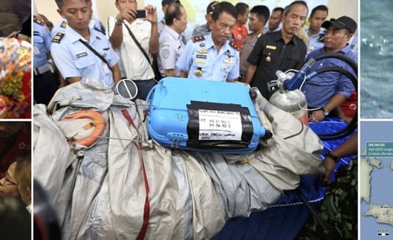First coffins of AirAsia flight are taken to airport where devastated relatives prepare to identify their loved ones