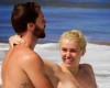 Miley Cyrus goes topless as she frolics in the ocean with boyfriend