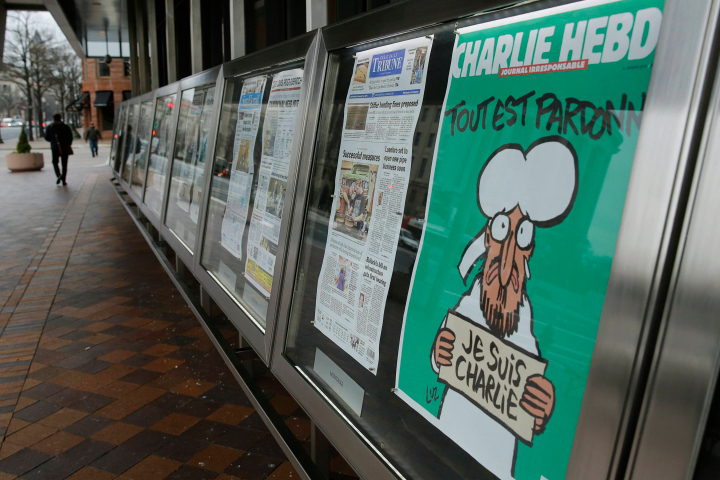 Copy of  latest edition of Charlie Hebdo is seen with U.S. newspapers at Newseum in Washington
