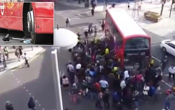 Amazing moment up to 100 people lift double decker bus off trapped unicyclist