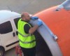 Shocked issue - A passenger snaps airport worker using tape on plane engine just the moments before take-off