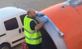 Shocked issue - A passenger snaps airport worker using tape on plane engine just the moments before take-off