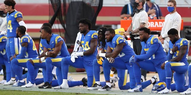 Los Angeles Rams players kneel during the national anthem before an NFL football game against the San Francisco 49ers in Santa Clara, Calif., Sunday, Oct. 18, 2020. (AP Photo/Jed Jacobsohn)