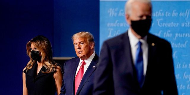 First lady Melania Trump, left, and President Donald Trump, center, remain on stage as Democratic presidential candidate former Vice President Joe Biden, right, walks away at the conclusion of the second and final presidential debate Thursday, Oct. 22, 2020, at Belmont University in Nashville, Tenn. (Associated Press)