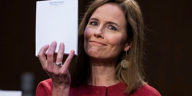 Supreme Court nominee Amy Coney Barrett holds up her notepad as she speaks during her confirmation hearing before the Senate Judiciary Committee on Capitol Hill in Washington, Tuesday, Oct. 13, 2020. (Tom Williams/Pool via AP)