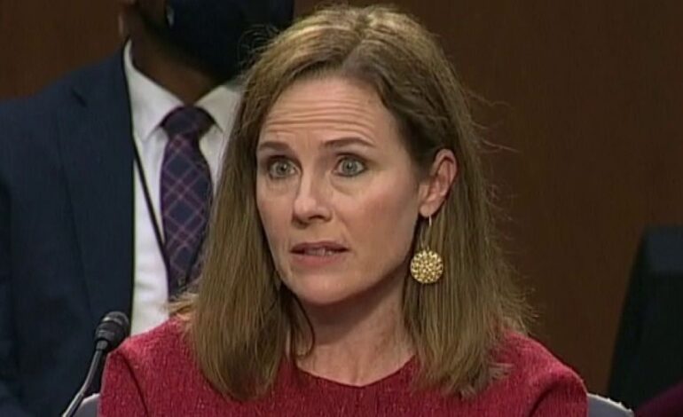 Amy Coney Barrett answers questions at confirmation hearing without notes, holds up blank notepad